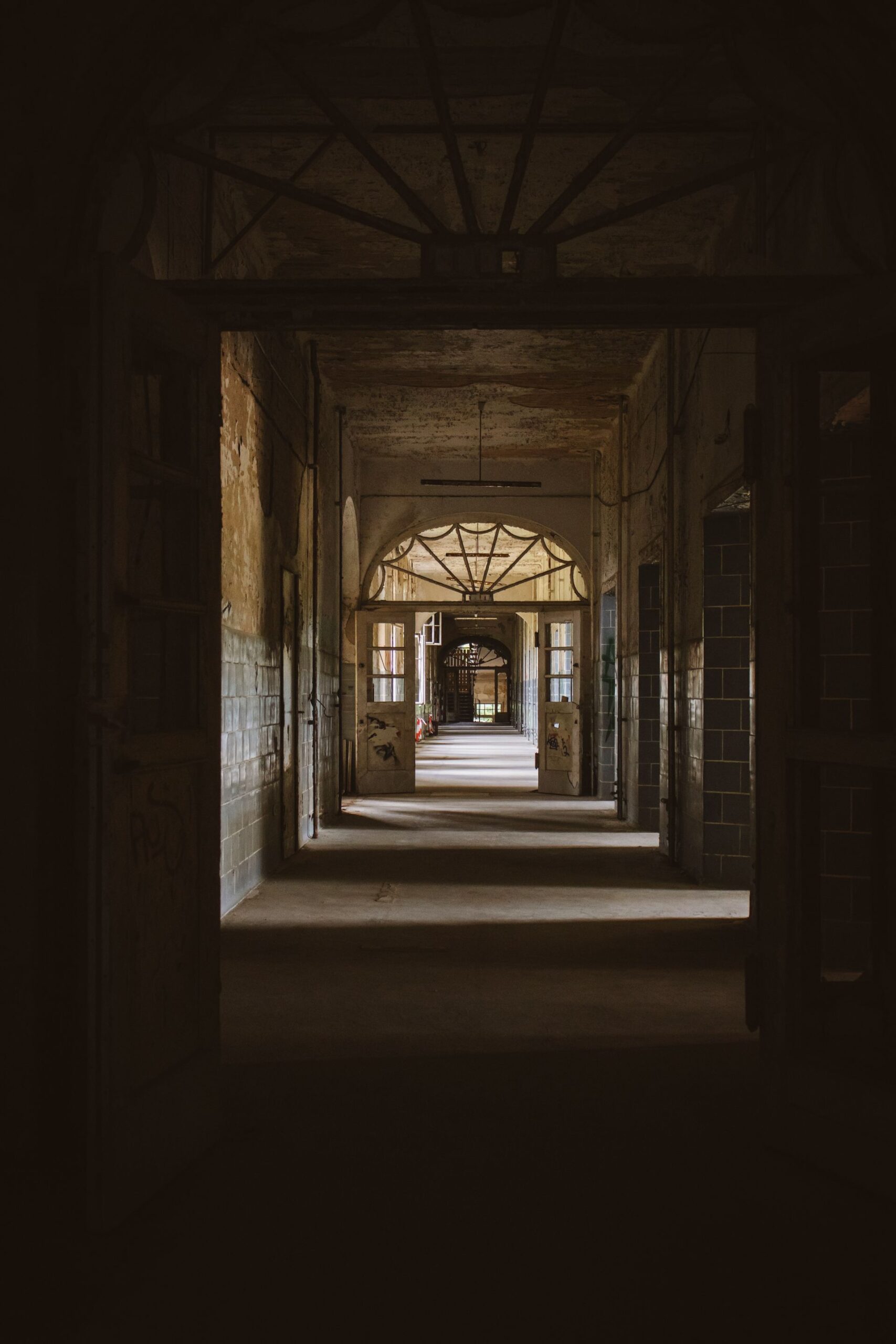 Dark abandoned corridor of a decaying historic building